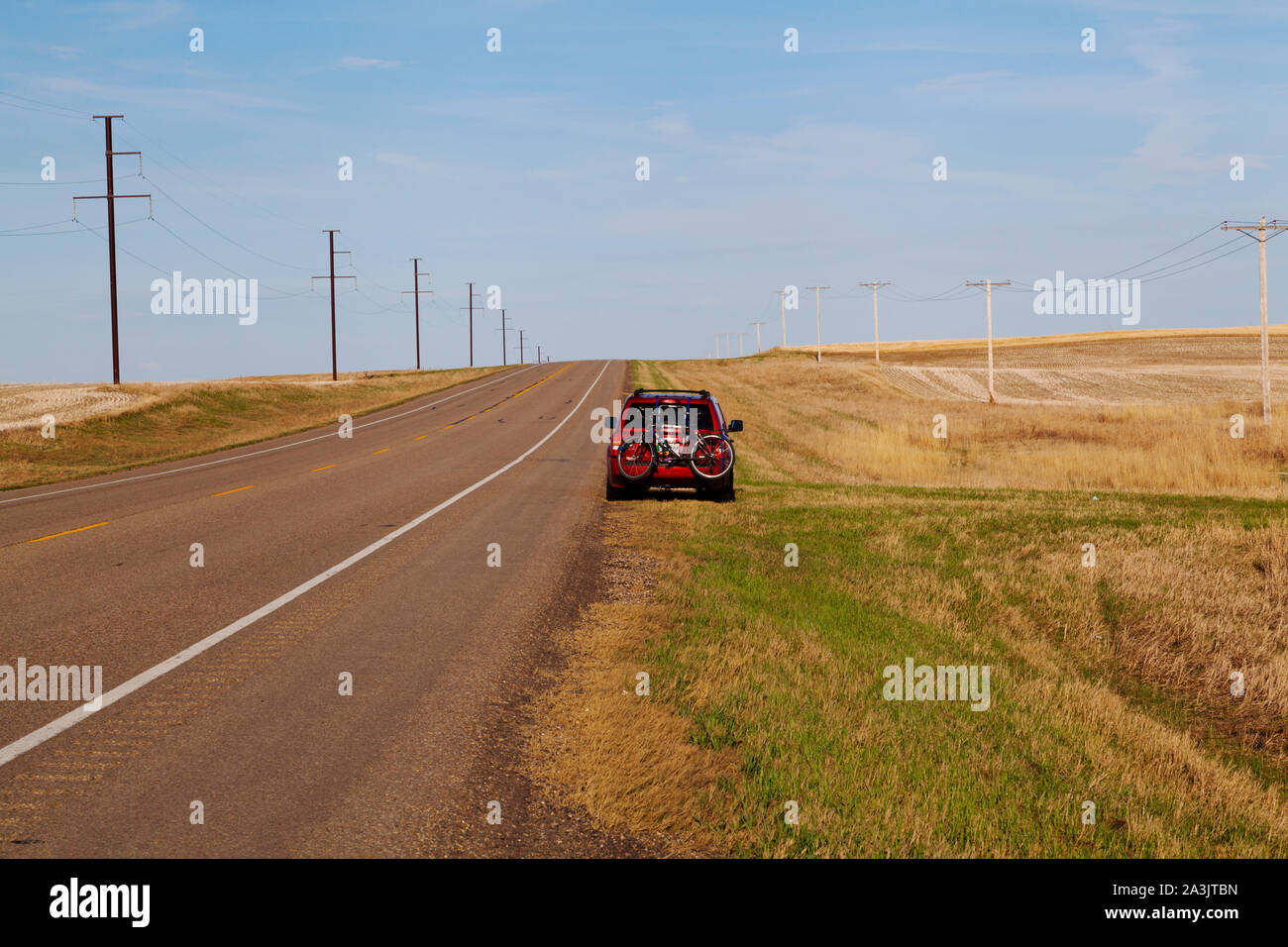 Road trip - car off road in rural Saskatchewan Stock Photo