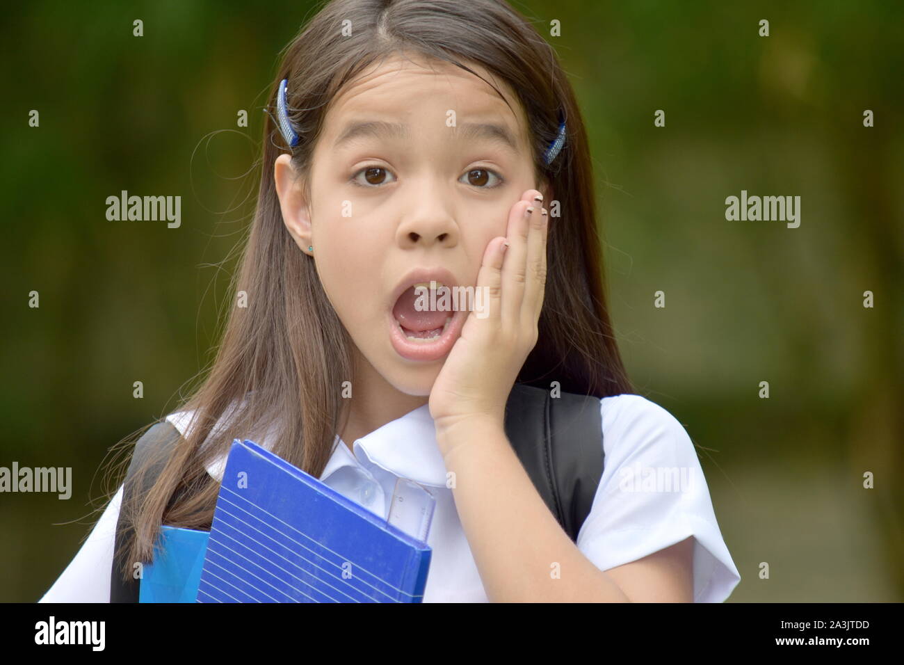 Shocked Cute Asian Girl Student Wearing Uniform With Notebooks Stock Photo