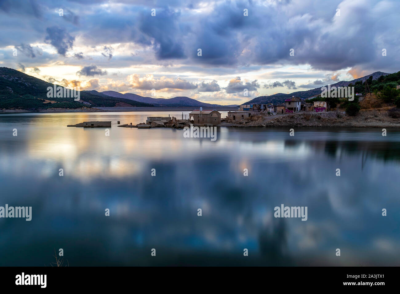 Reflections on a lake near sunk village Sfentyli - Stock Image