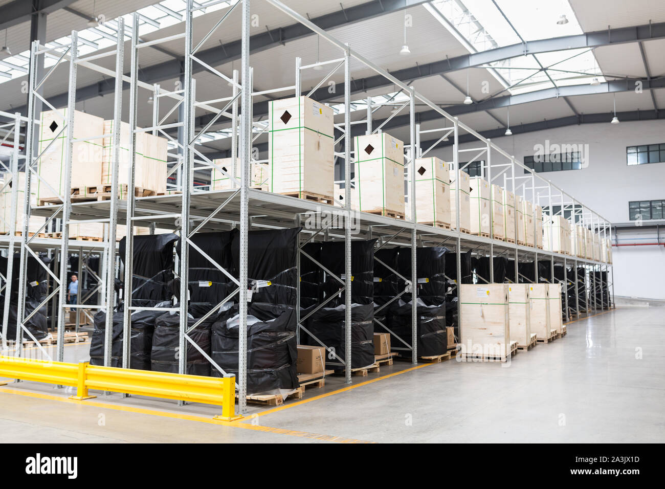 Large hangar warehouse of industrial and logistics companies. Long shelves with a variety of boxes. industry space and hardware box for delivery Stock Photo
