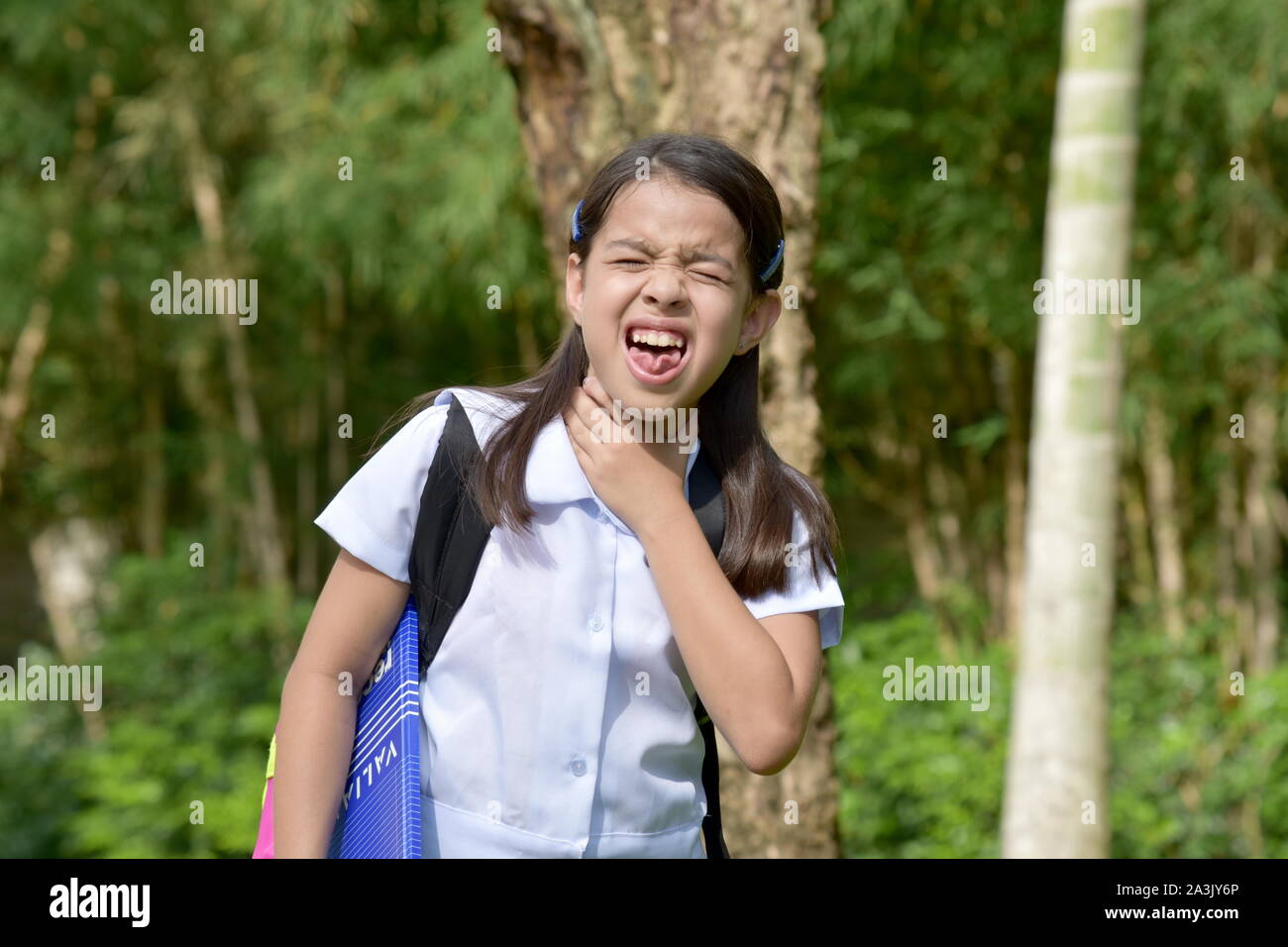 A Female Student Choking With Notebooks Stock Photo