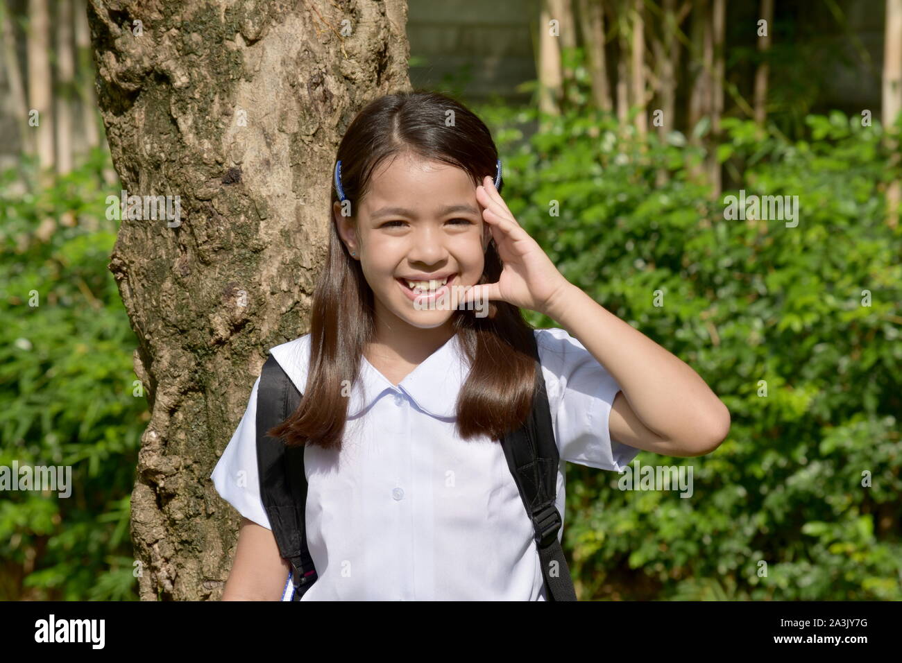 Girl Student Decision Making Wearing Uniform With Books Stock Photo