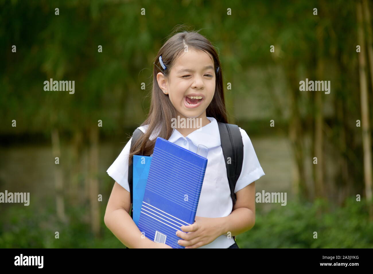 Diverse Student Child Making Funny Faces With Books Stock Photo