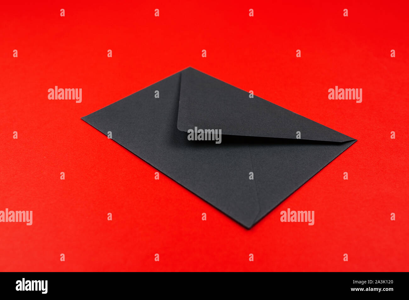 Junk mail or spam and fake letter idea. Concept for unsolicited mail or e-mail. Envelope on red background Stock Photo