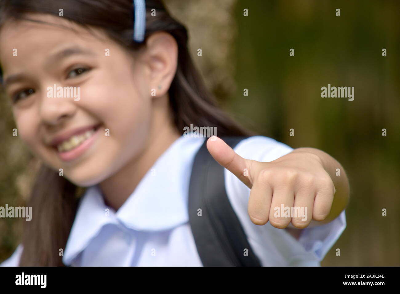 Proud Asian Person Wearing Uniform With Books Stock Photo