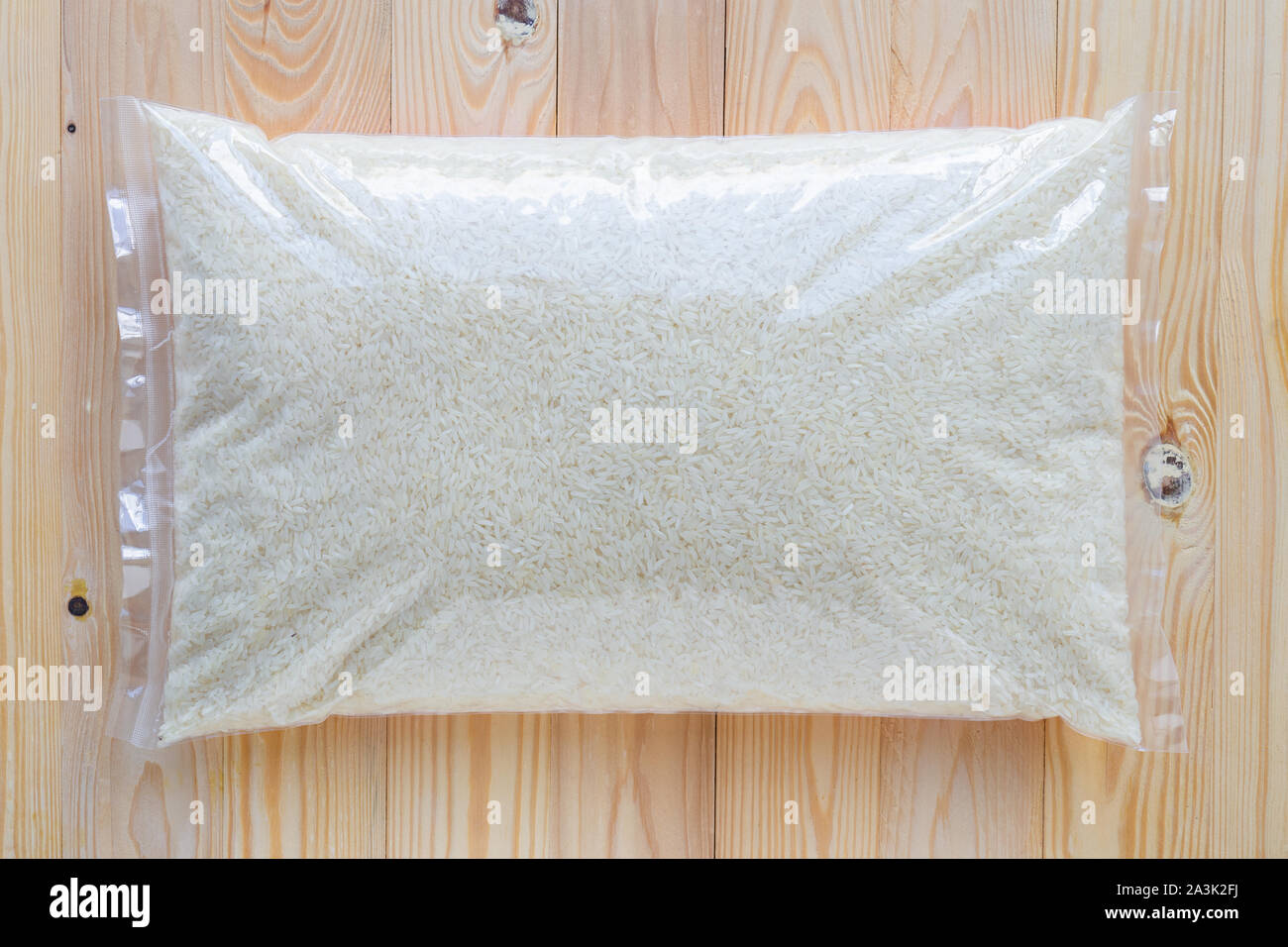 Download Rice In A Clear Plastic Bag On A Wooden Floor Stock Photo Alamy
