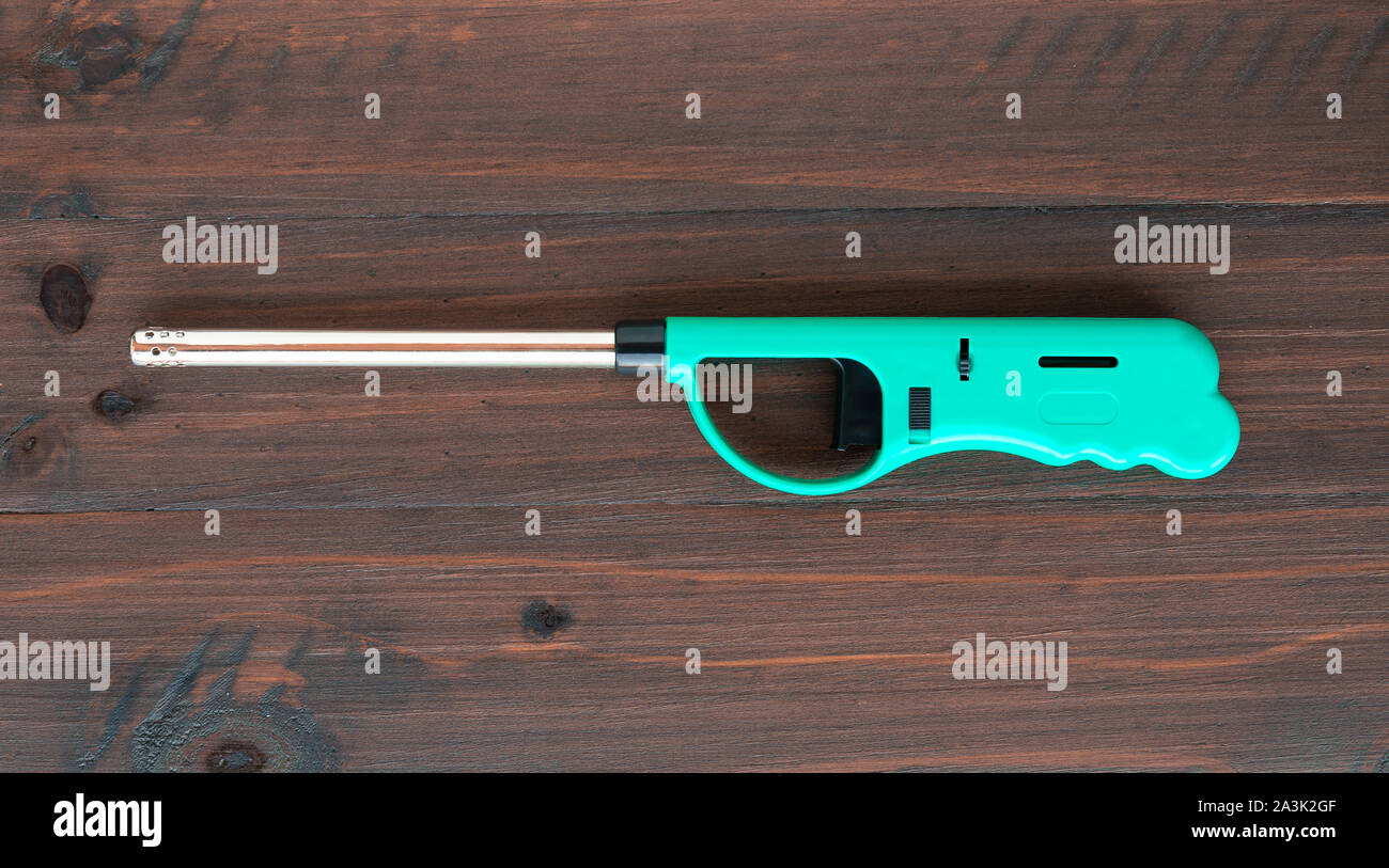 Gas lighter gun for gasstove on a wooden background Stock Photo Alamy