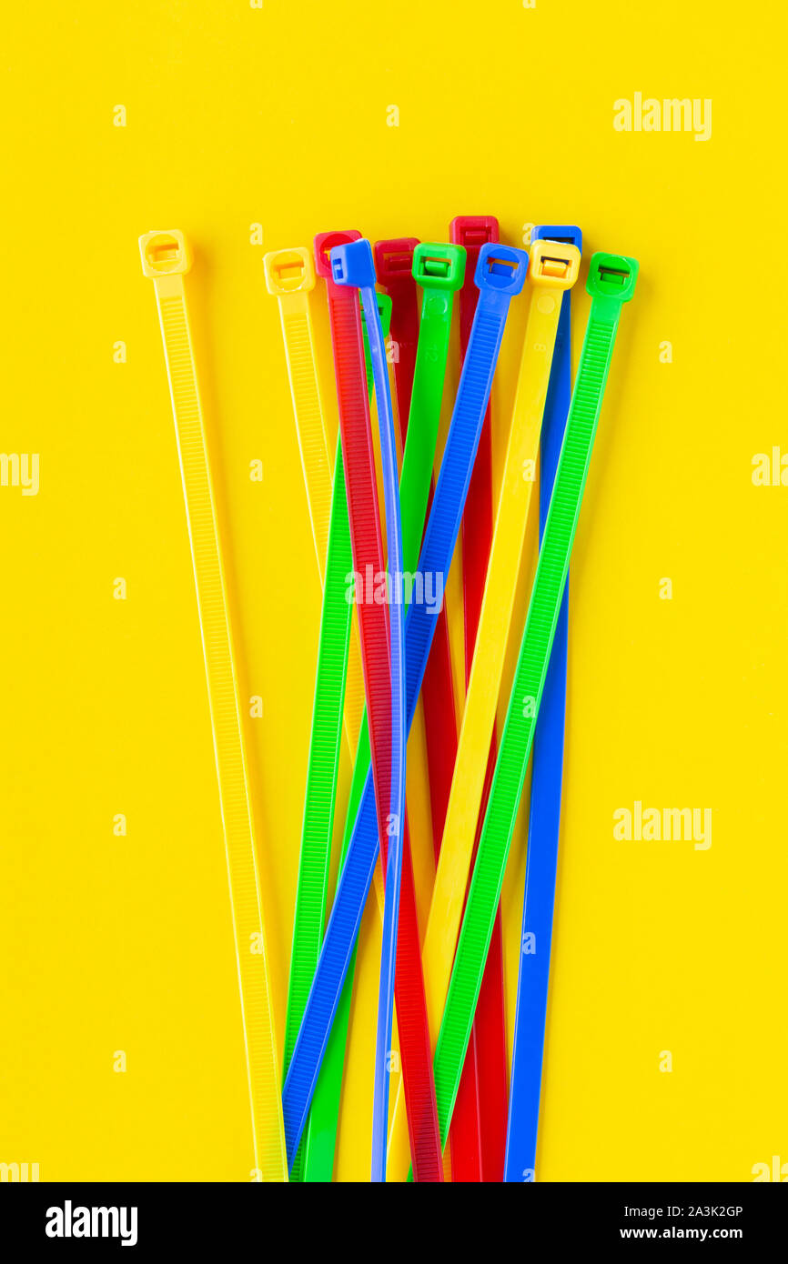 Nylon cable ties on a yellow background Stock Photo