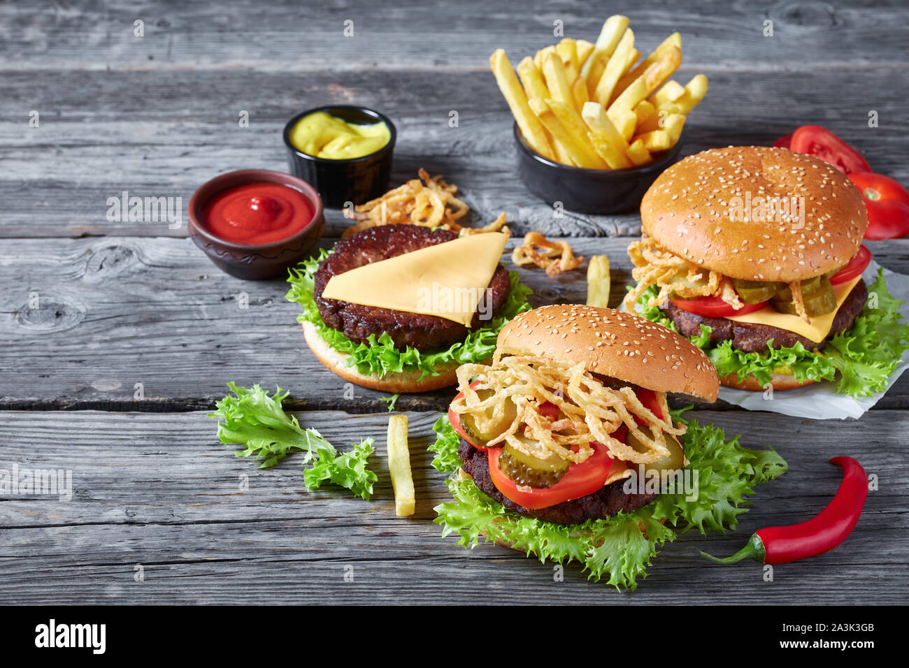 three Cheeseburgers with beef patties, cheddar cheese, crispy fried
