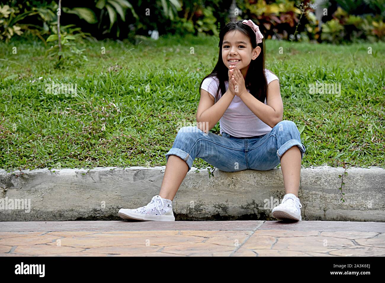 A Praying Petite Filipina Female Stock Photo