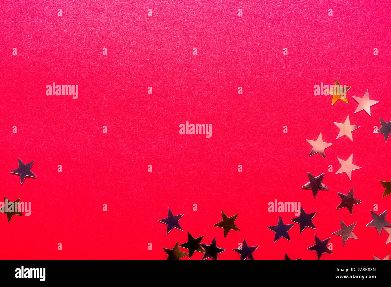 Gold stars on bright red background, abstract image Stock Photo