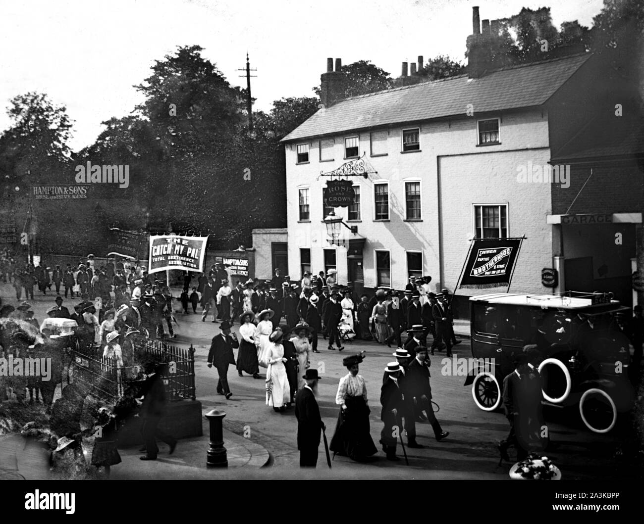 Baptists and other similar groups including the Total Abstinence Association marching past the Rose & Crown pub on the High Street in Wimbledon c1907 Photo by Tony Henshaw Archive Stock Photo
