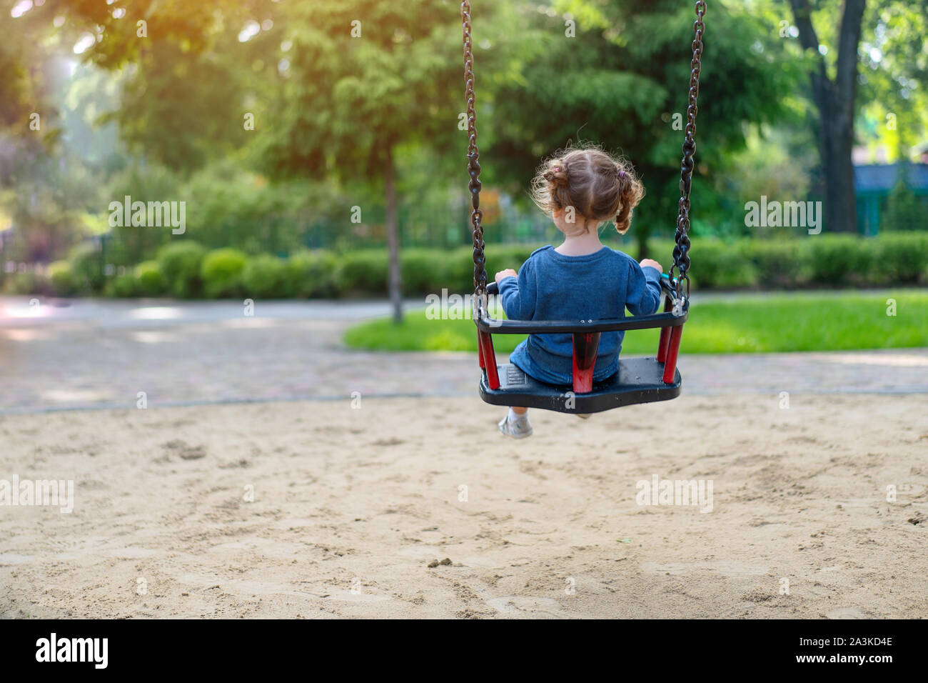 Boy and girl sharing swing on summer day in Sweden Stock Photo - Alamy