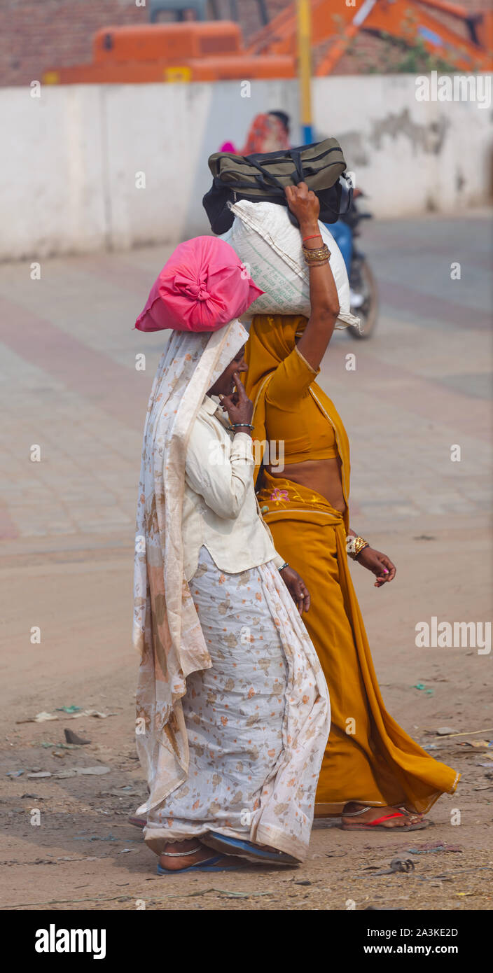 Indian women with bags on her head Stock Photo