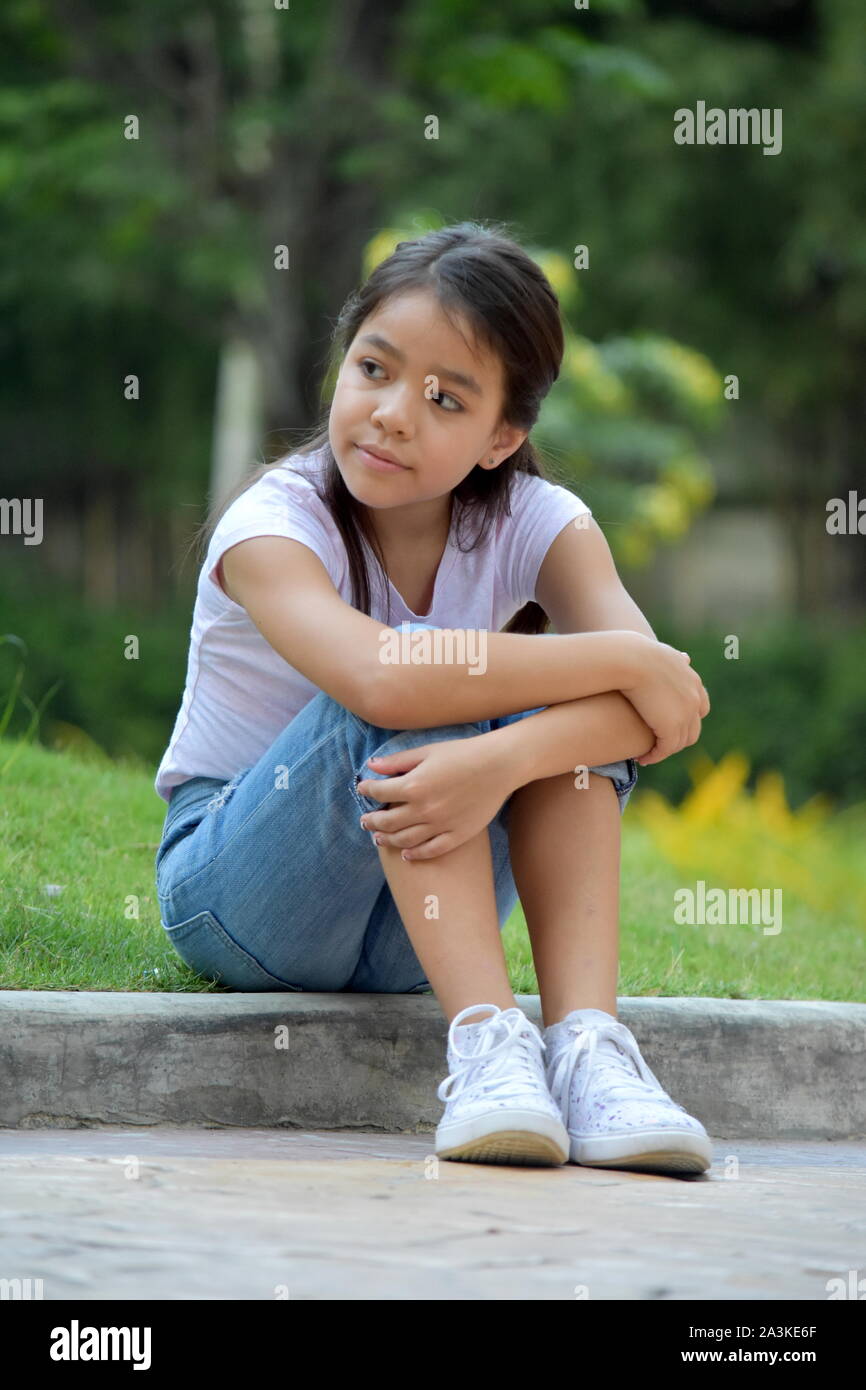 Serious Young Minority Female Juvenile Sitting Stock Photo - Alamy
