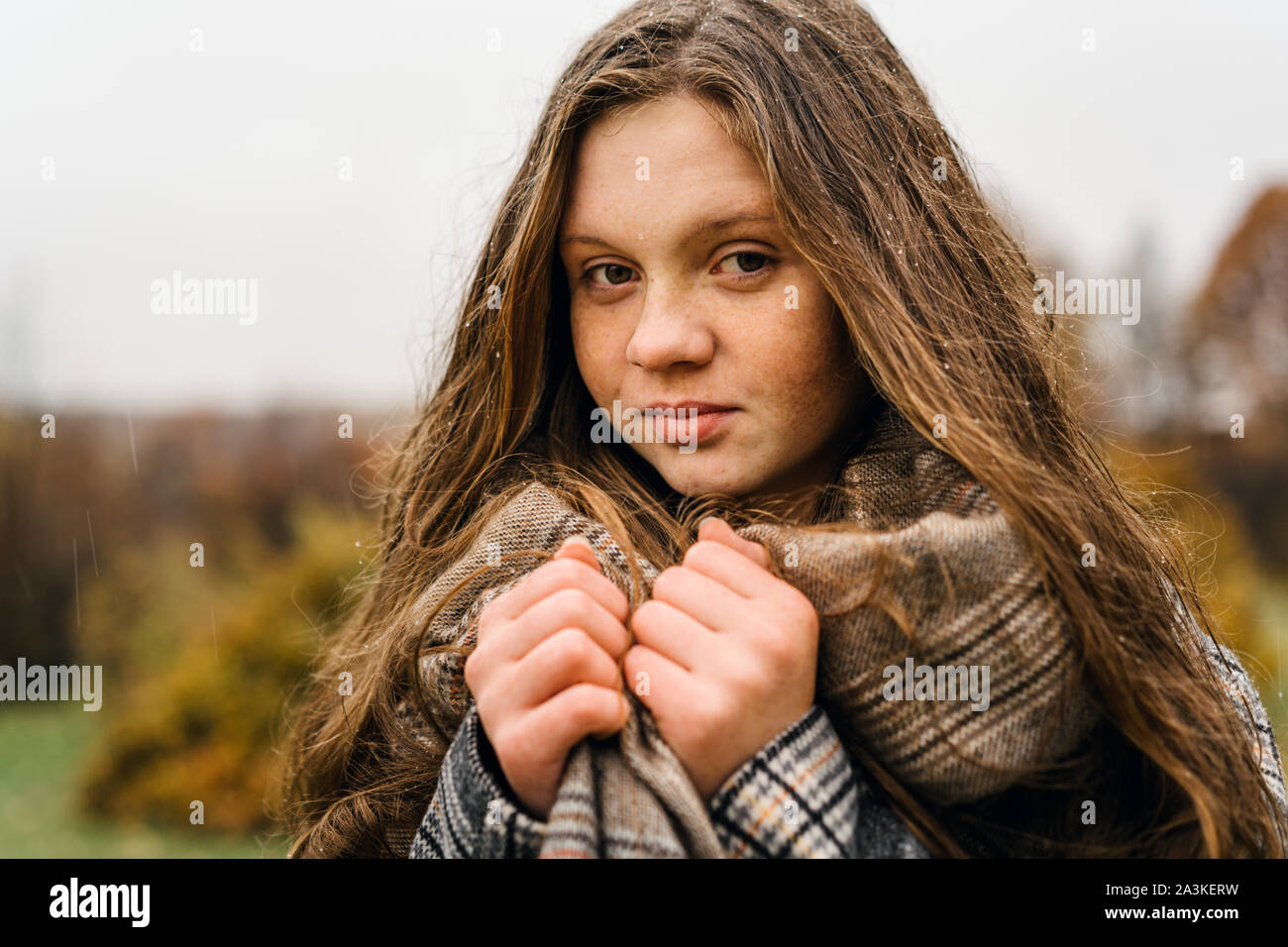 Red-headed freckled girl in autumn yellow park. Stock Photo
