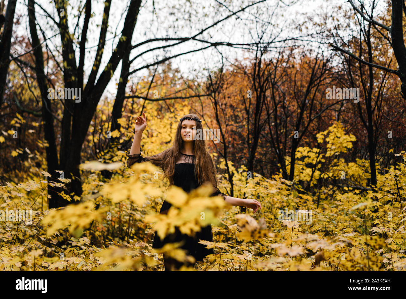 Freckled redhead girl in autumn yellow park Stock Photo