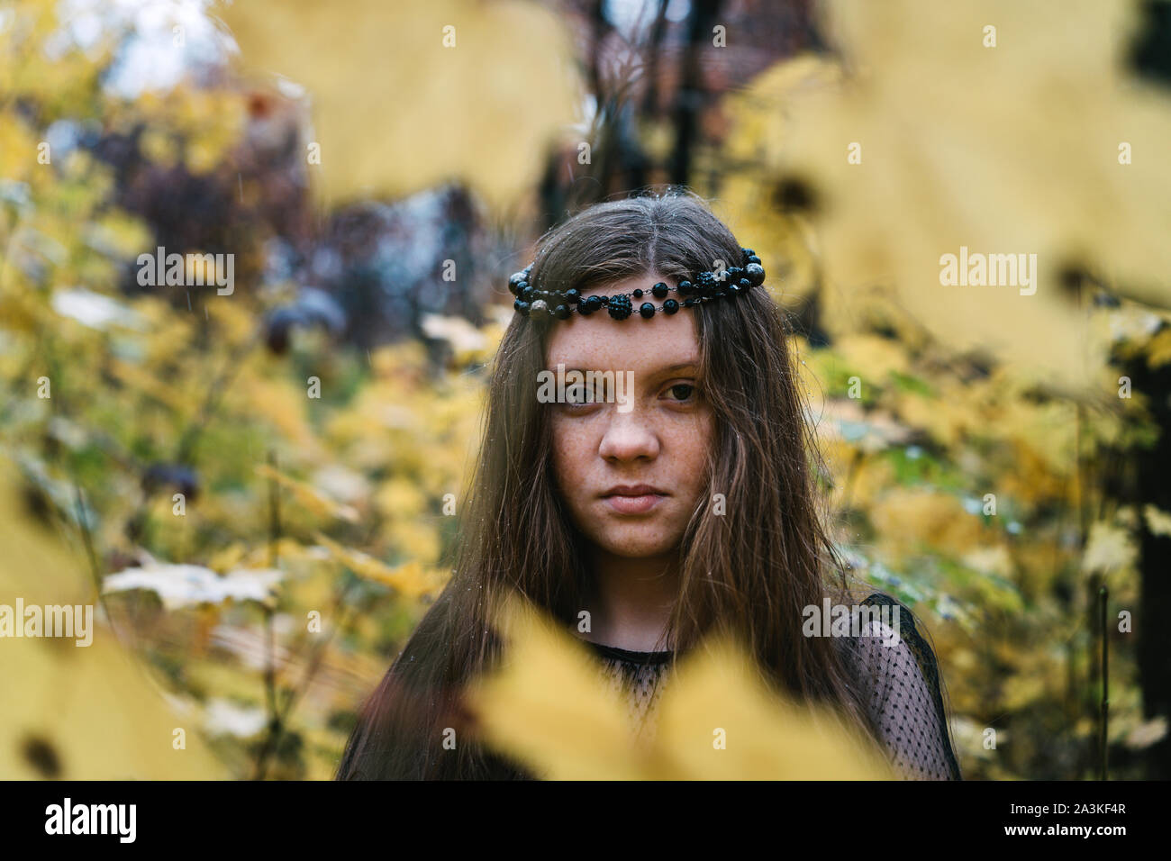 Freckled redhead girl in autumn yellow park Stock Photo