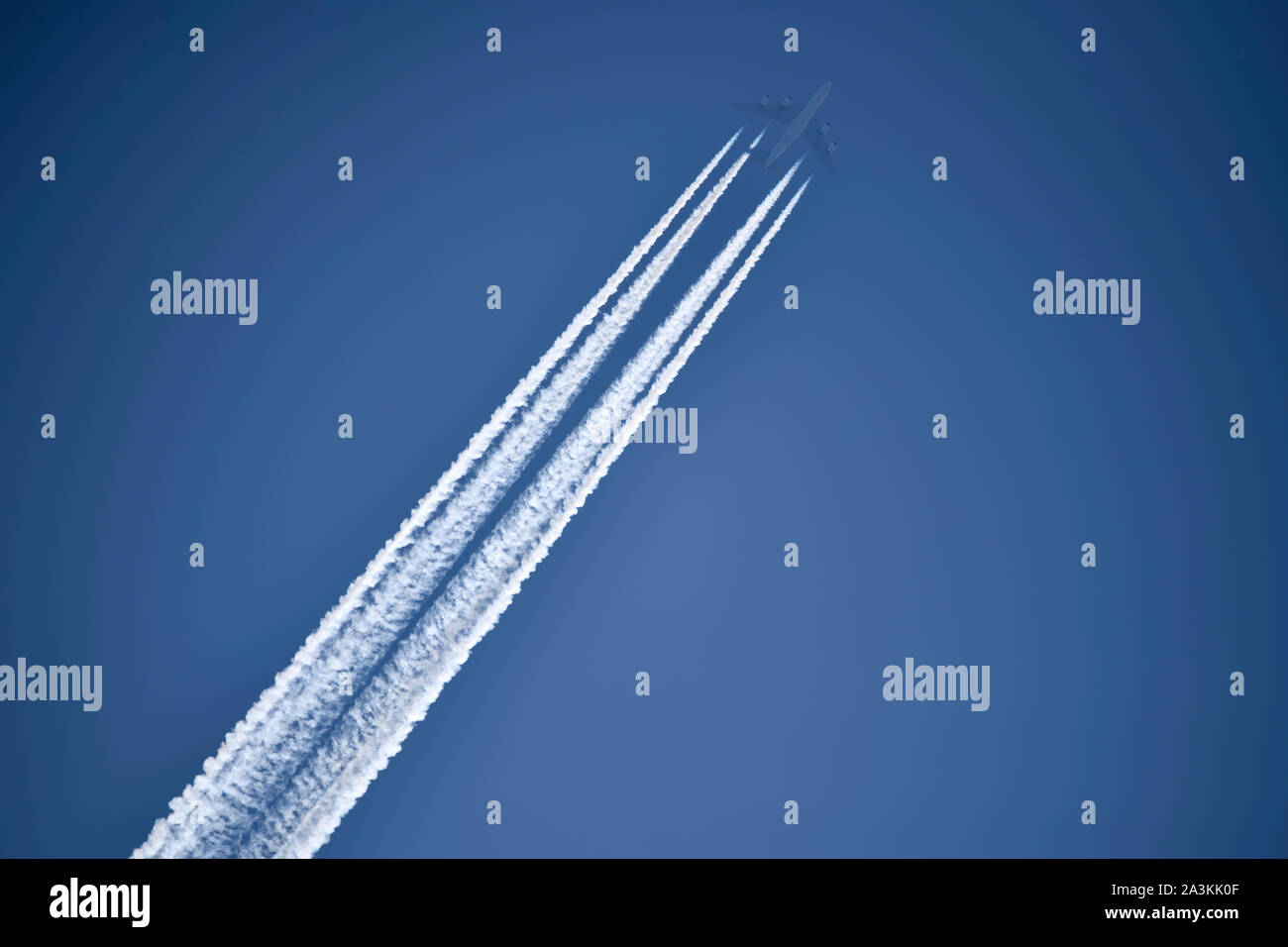 Aircraft with contrails Stock Photo