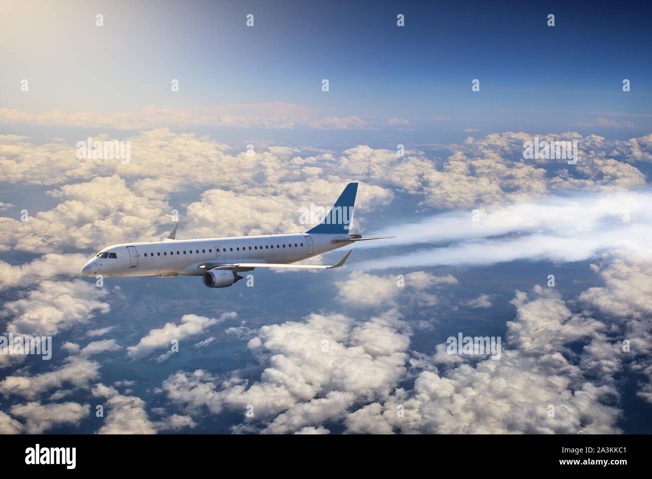passenger plane is flying above the clouds Stock Photo - Alamy