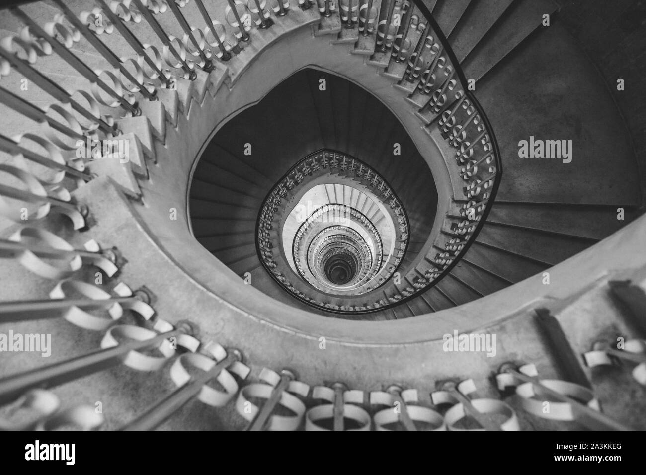 Very deep descending spiral staircase Stock Photo