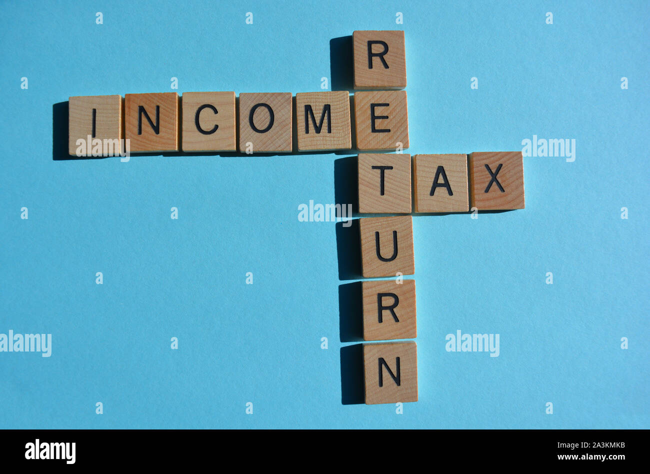 Income Tax Return in 3d wooden alphabet letters isolated in crossword Income Tax Return in 3d wooden alphabet letters isolated in crossword