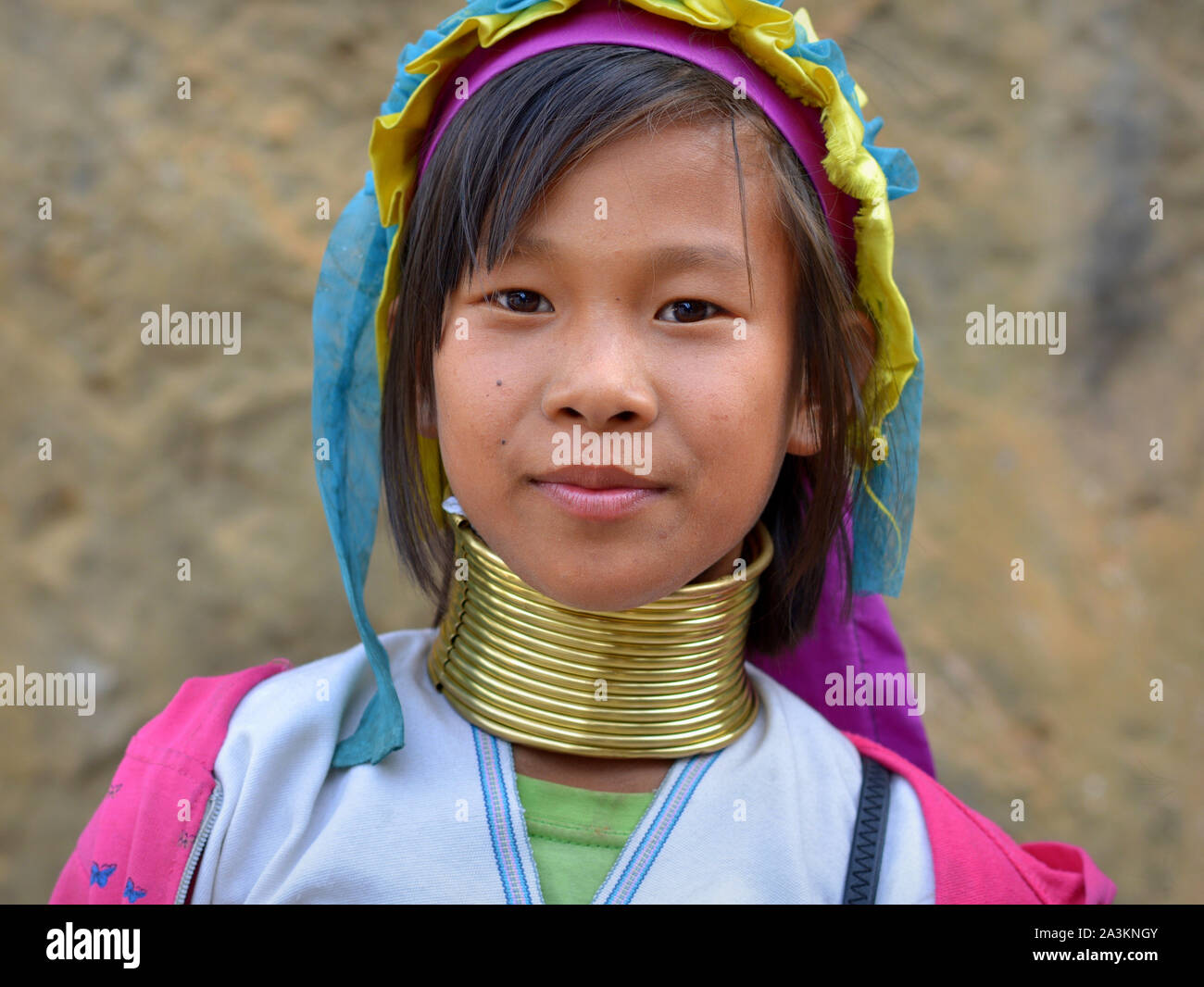 Pretty Myanmarese Kayan Lahwi pre-teen girl with tribal brass neck rings/coils poses for the camera. Stock Photo