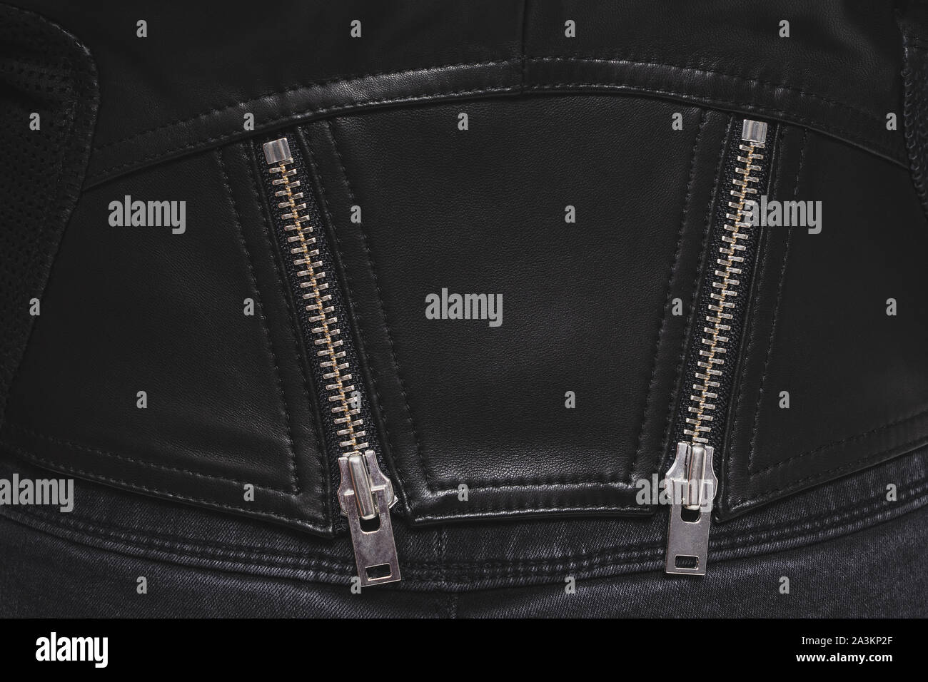 Back of a stylish leather jacket with two metal zippers and clasps