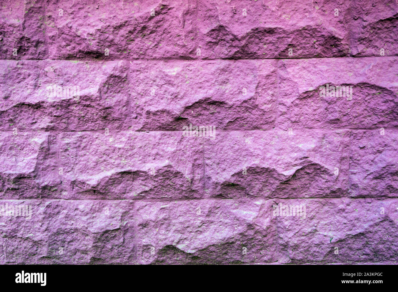 Texture of rough brick painted purple wall. Vintage violet brick background. Stock Photo