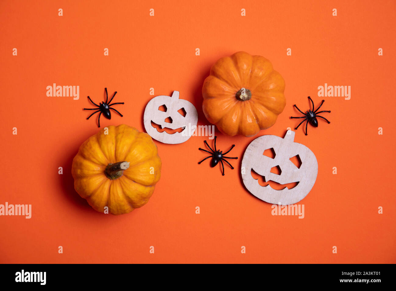Orange halloween background with pumpkins and spiders Stock Photo - Alamy