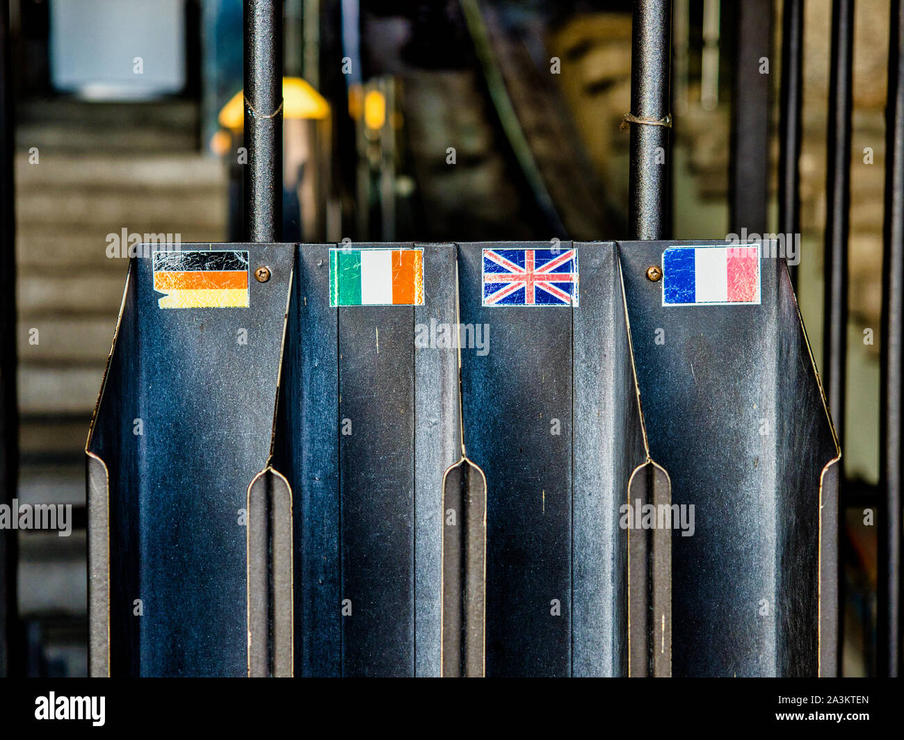 Flags of Germany, Italy, England and France indicate in a metal container the respective language of the tourist brochures Stock Photo