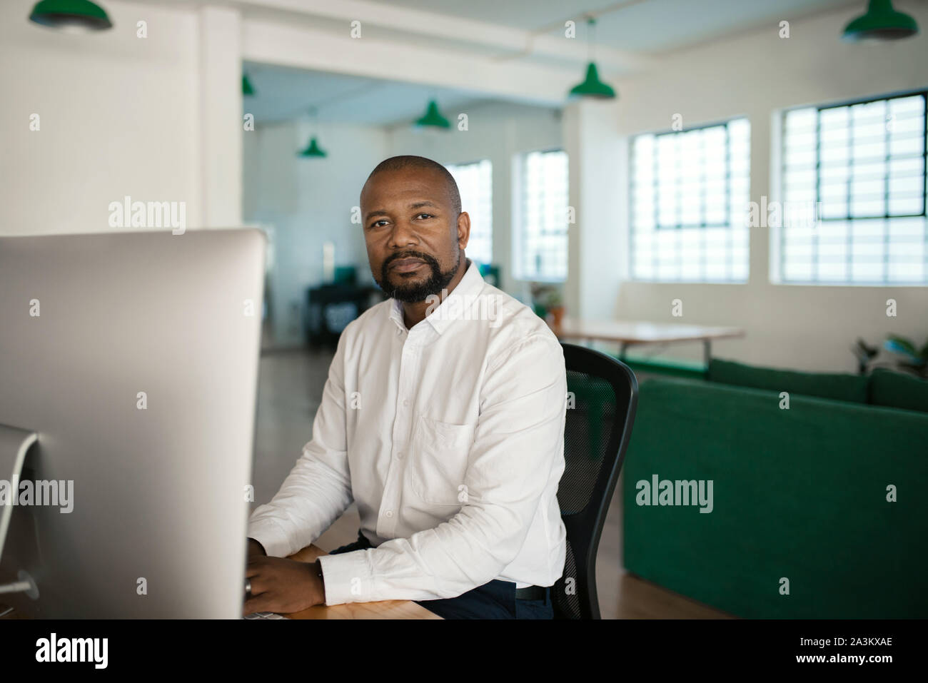 African American businessman using a computer at his office desk Stock Photo