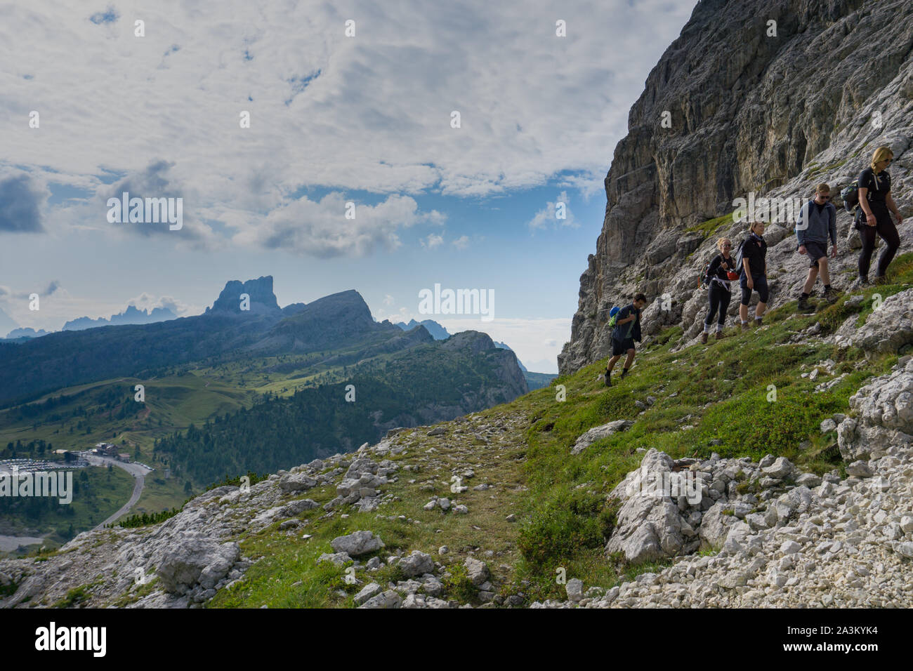 group of mountain climbers hiking up a mountain side to a hard climbing