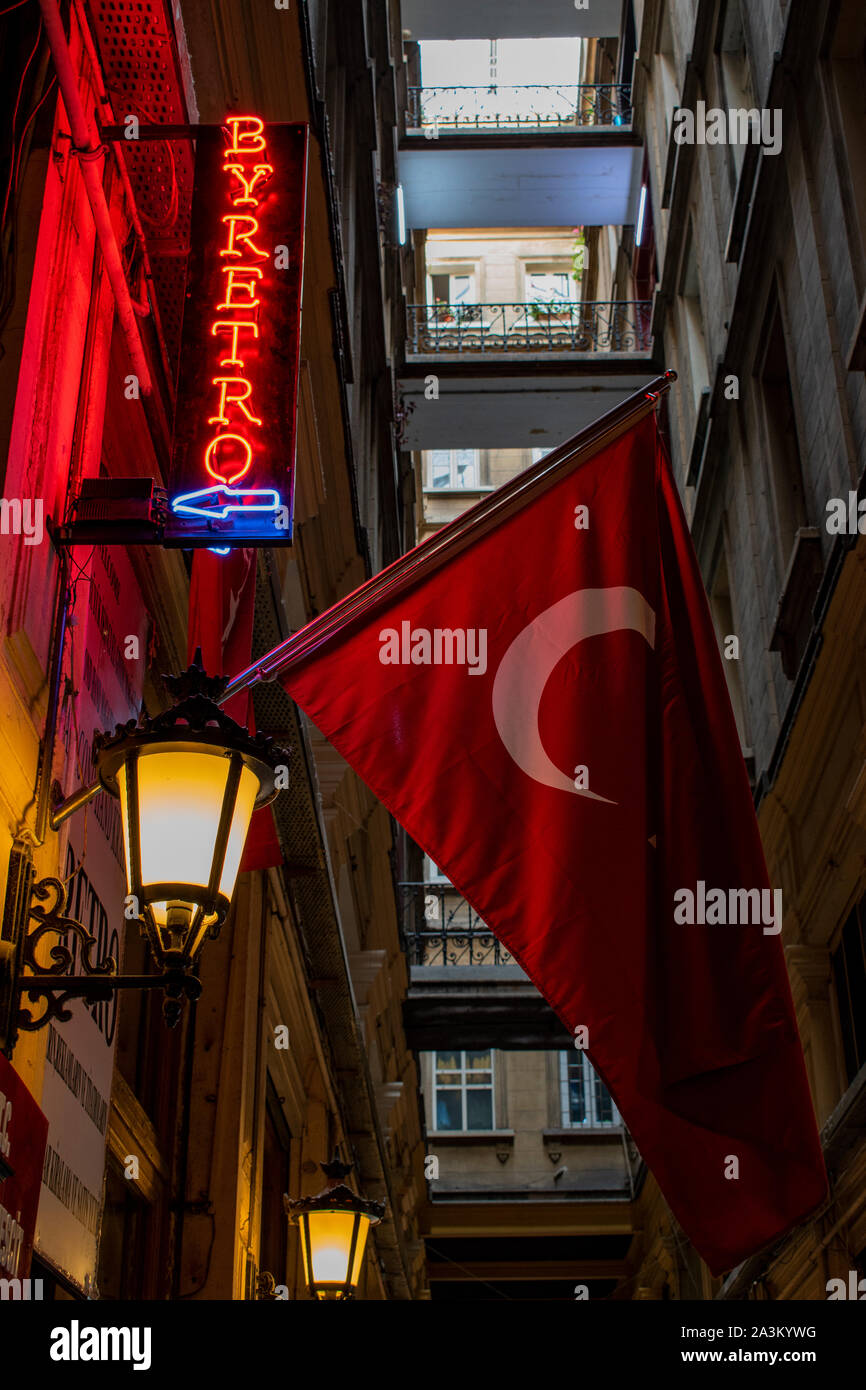 Istanbul: Turkish flag and the sign of a barber shop inside the Cicek Pasaji, the Flower Passage, historic galleria on Istiklal Caddesi, famous avenue Stock Photo