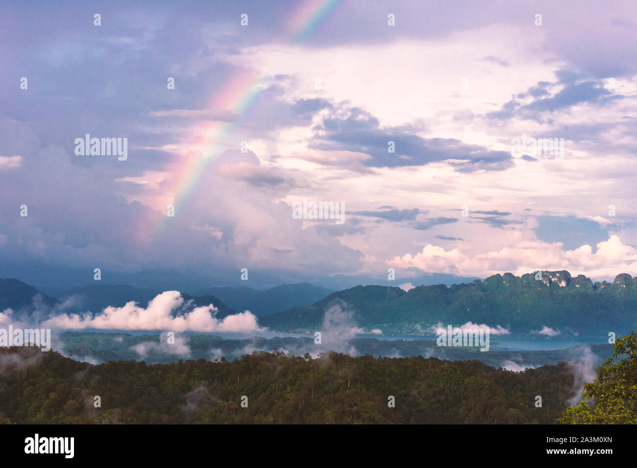 Landscape with rainbows and clouds background. Stock Photo