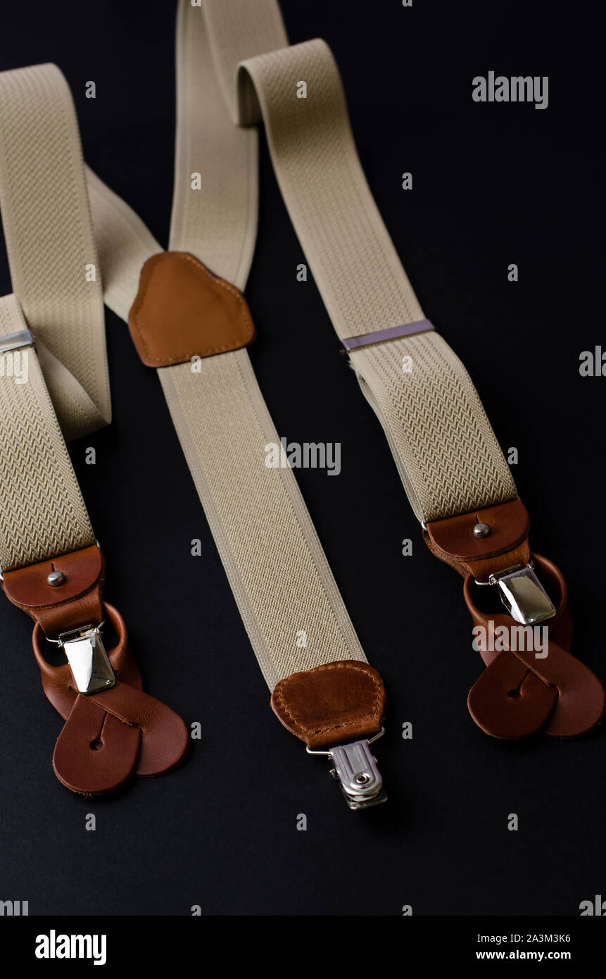 Stylish male braces or suspenders on black background.Top view, vertical image Stock Photo