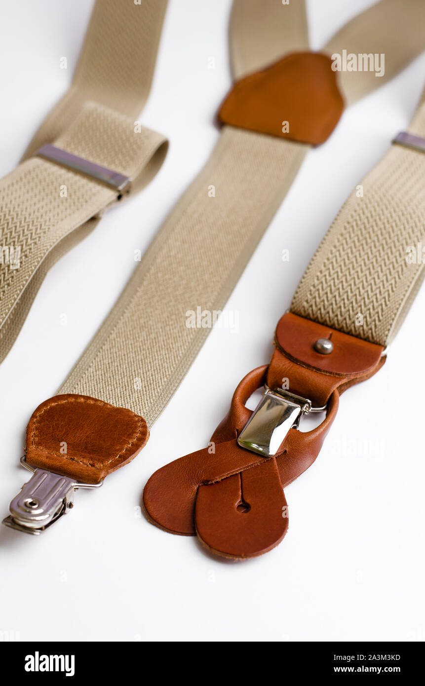 Close-up on brown Leather details of suspenders on white background, vertical Stock Photo
