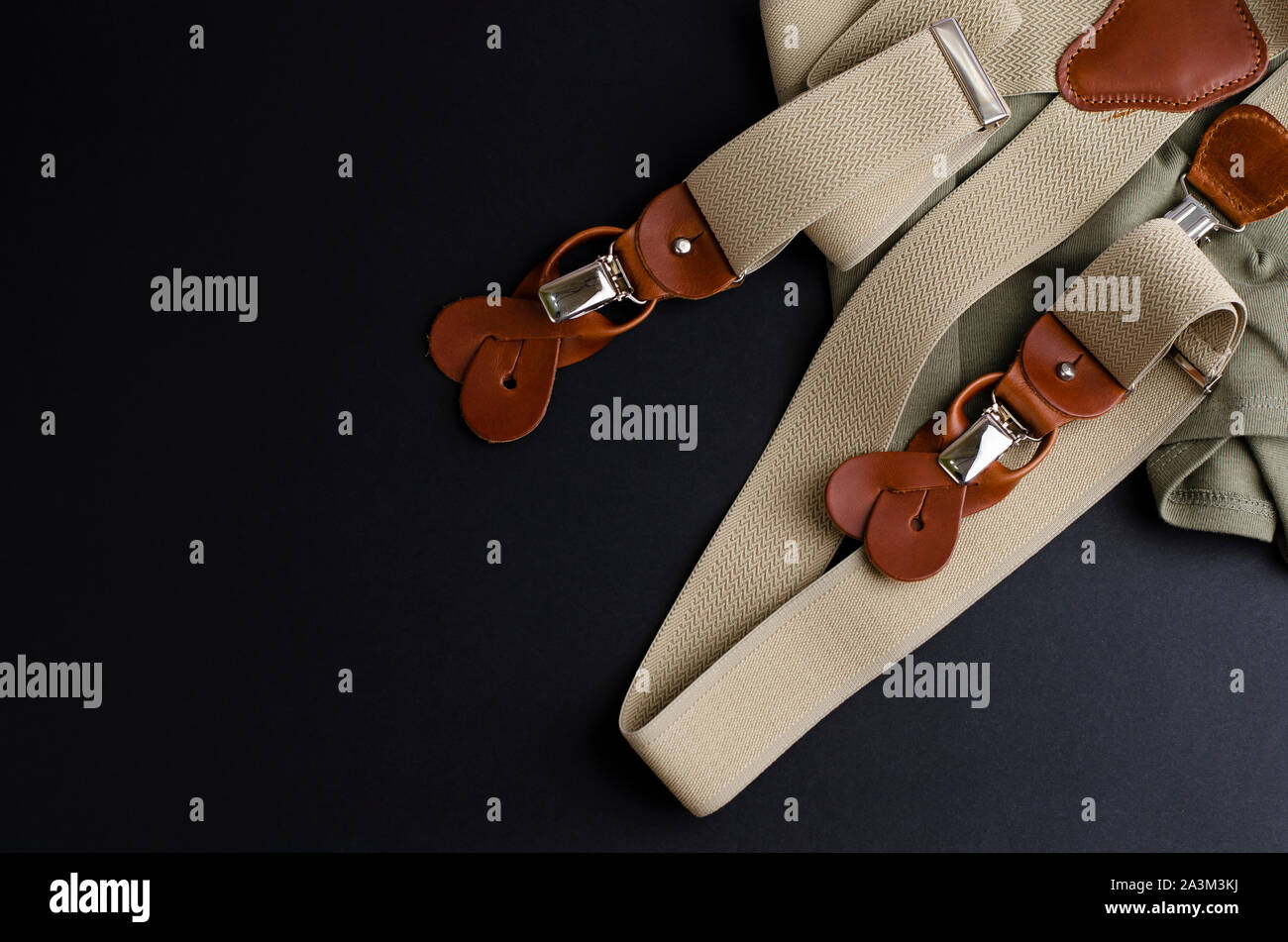 Male suspenders with leather details on black background with copoy space. Hipster style concept Stock Photo