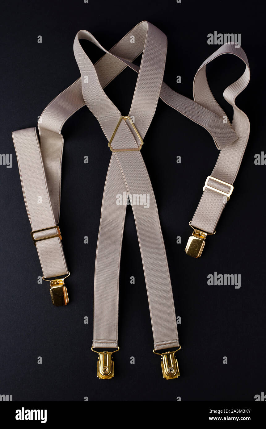 Stylish male braces or suspenders on black background.Top view, vertical image Stock Photo