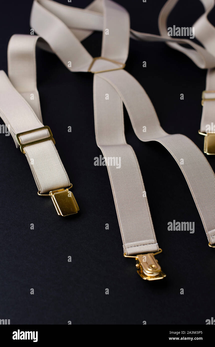 Vintage male braces or suspenders on black background.Top view, vertical image Stock Photo