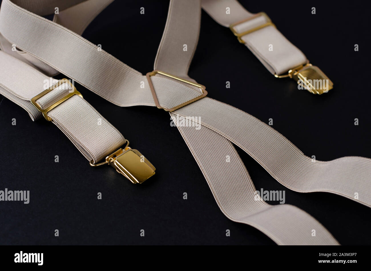 Stylish male braces or suspenders on black background.Top view Stock Photo