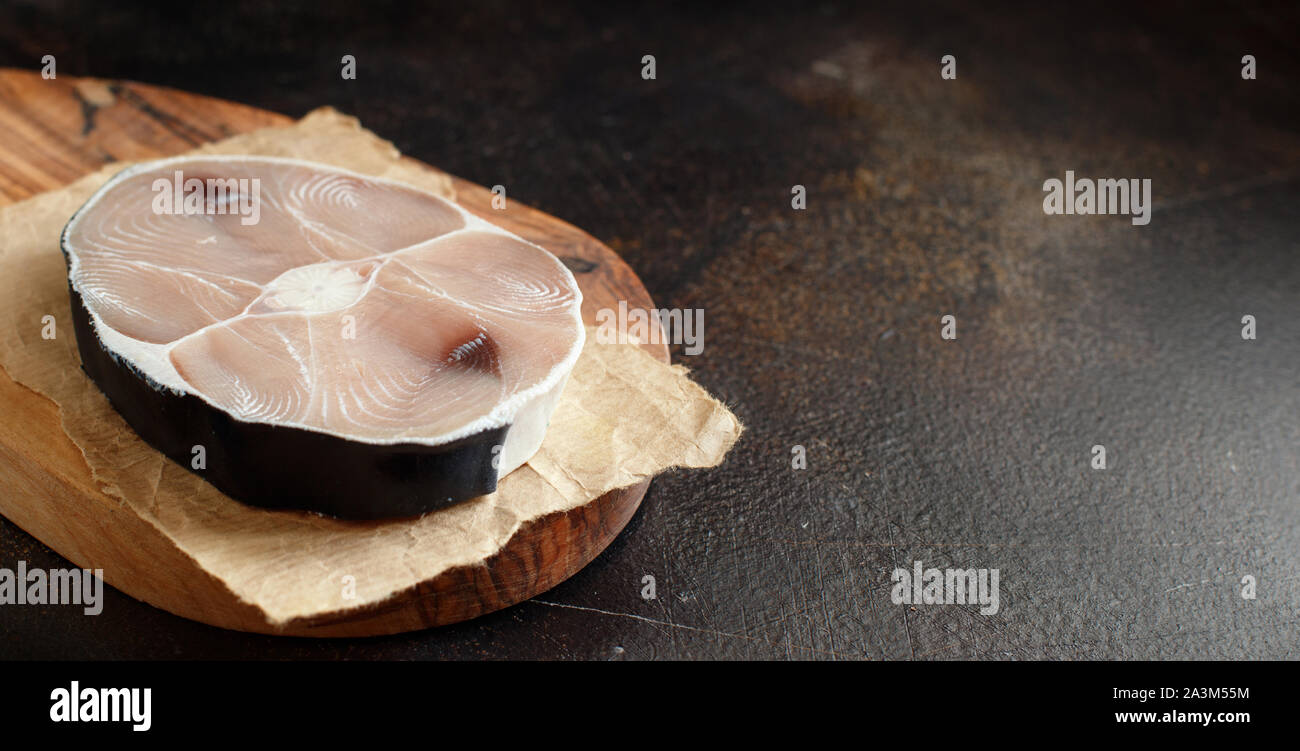 Two shark steaks on a dark board close up Stock Photo