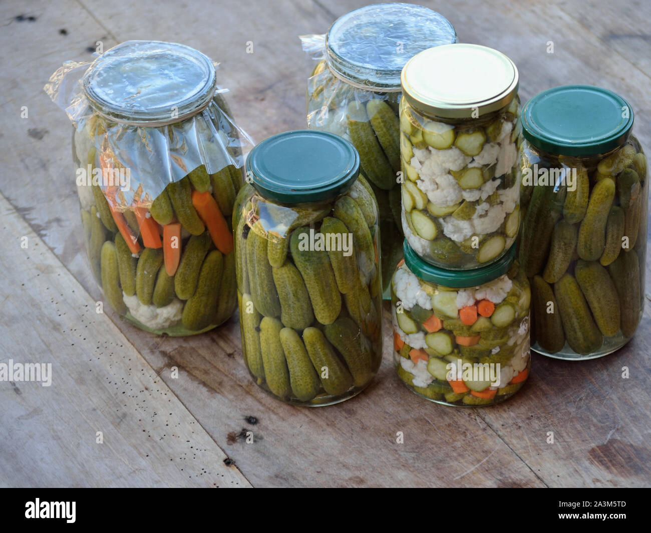 Homemade pickles, fermented vegetables. Pickled cucumber, cauliflower and carrot (Zimnica) Stock Photo