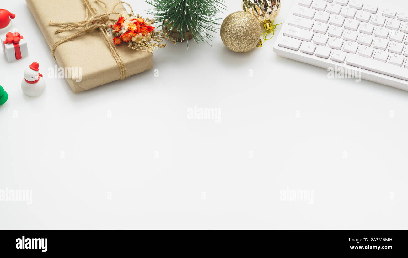 Merry Christmas and Happy new years office work space desktop concept. Flat lay top view with keyboard and Christmas ornaments with copy space. Stock Photo