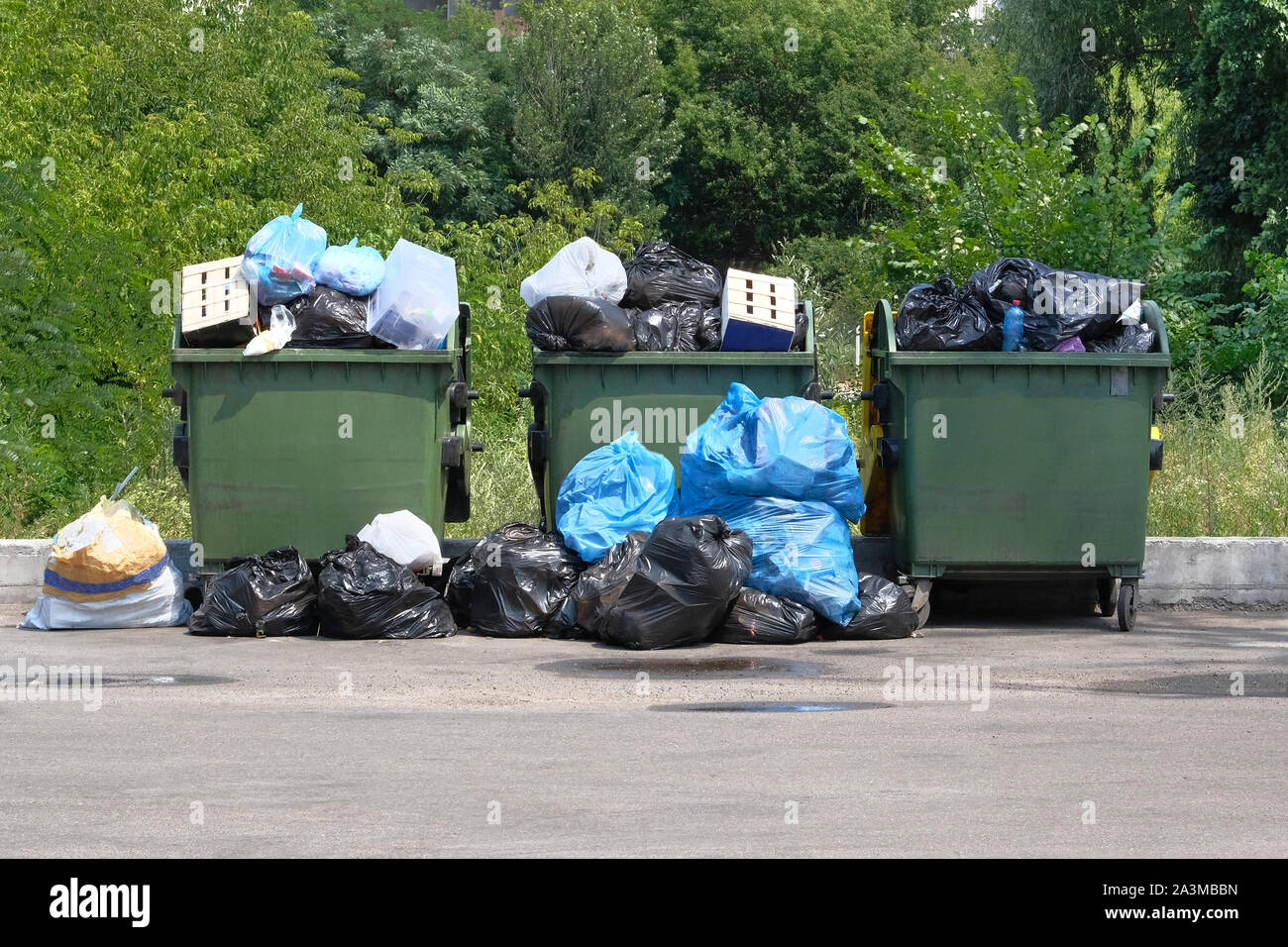 Dumpsters being full with garbage. Garbage is pile lots dump. Garbage