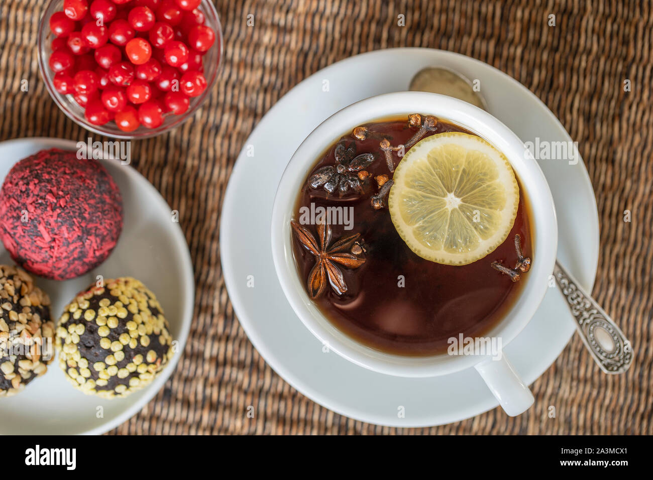 Spice tea, consisting of cinnamon, black pepper, cardamom, star anise, lemon, cloves and hot apple juice. Close up, top view. Cinnamon tea. Tea drink Stock Photo