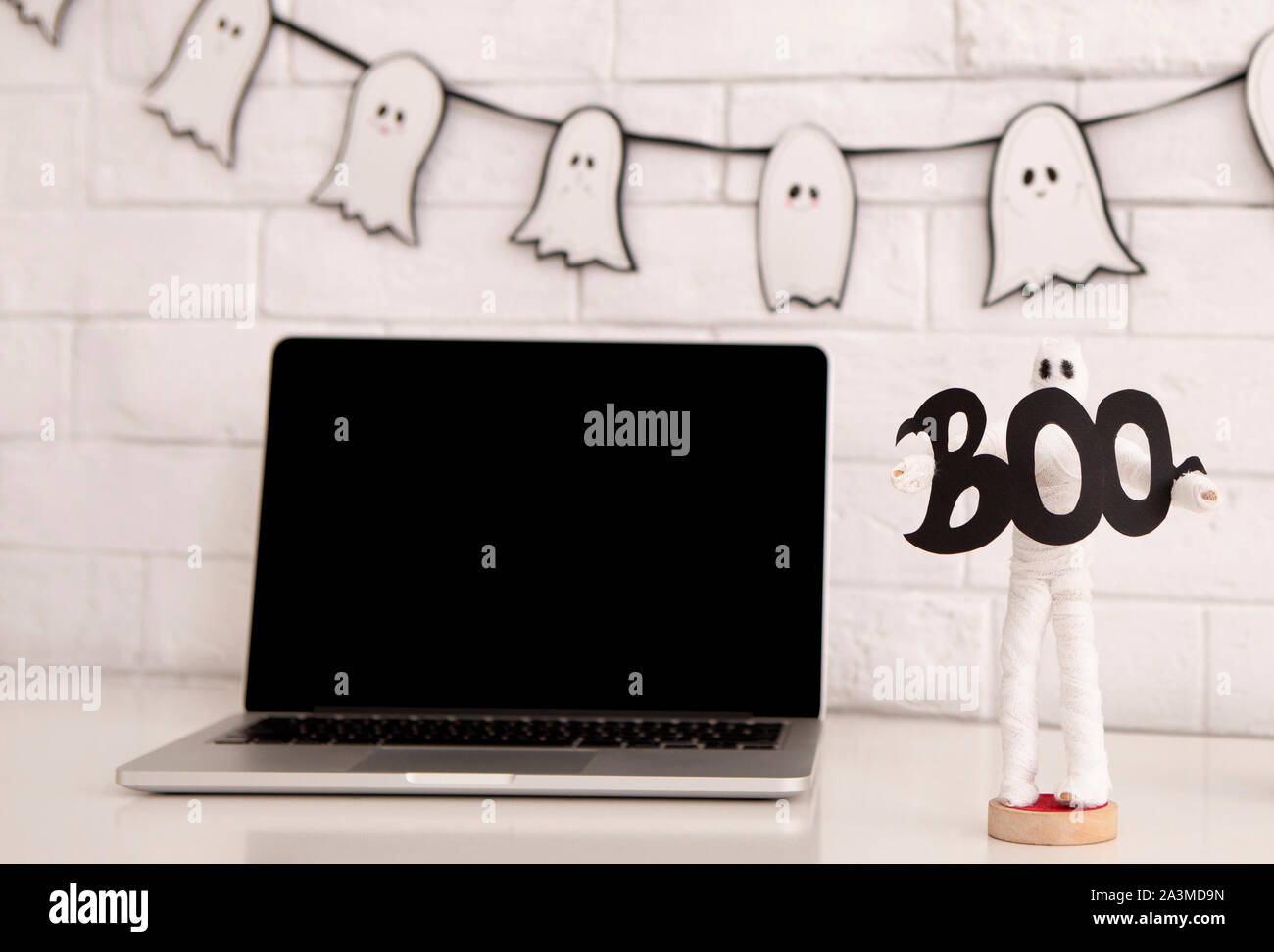 Modern laptop with blank screen on office table Stock Photo - Alamy