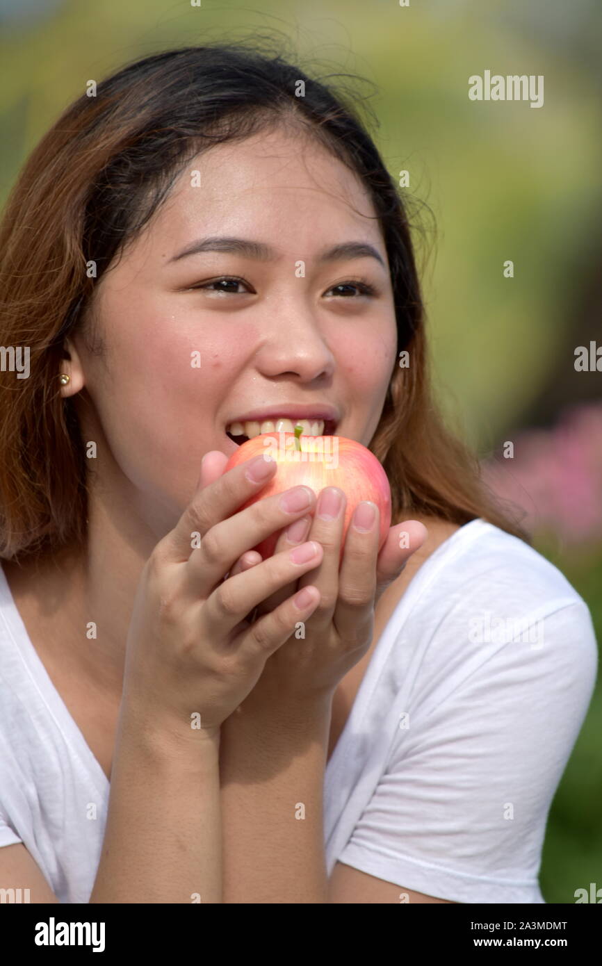An Eating Young Female With Fruit Stock Photo