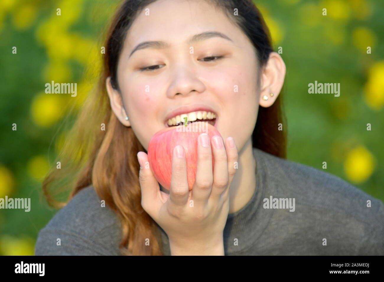 Eating Youthful Filipina Female With An Apple Stock Photo