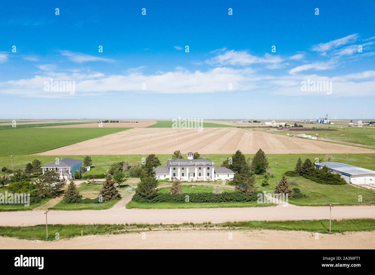 Historic white estate home in rural america, large expansive fields and